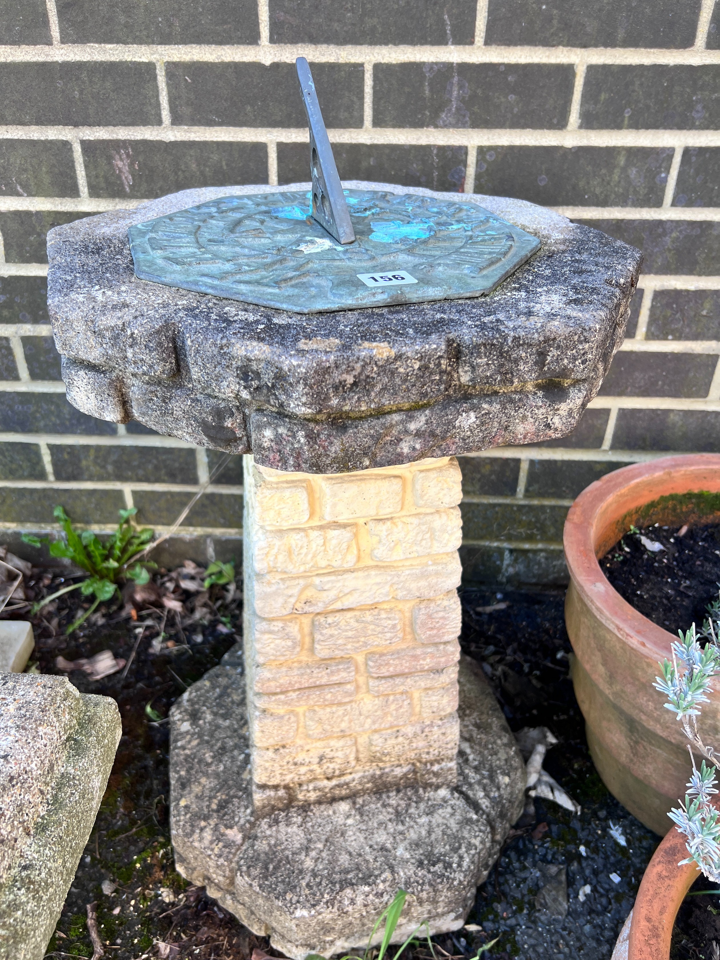 An octagonal reconstituted stone sundial on brick effect pillar, height 75cm *Please note the sale commences at 9am.